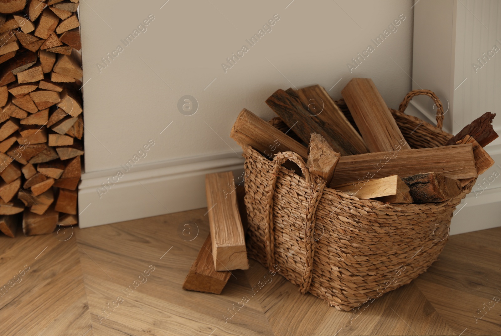 Photo of Basket with firewood on floor in room