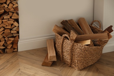 Basket with firewood on floor in room