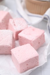 Delicious sweet marshmallows on white table, closeup