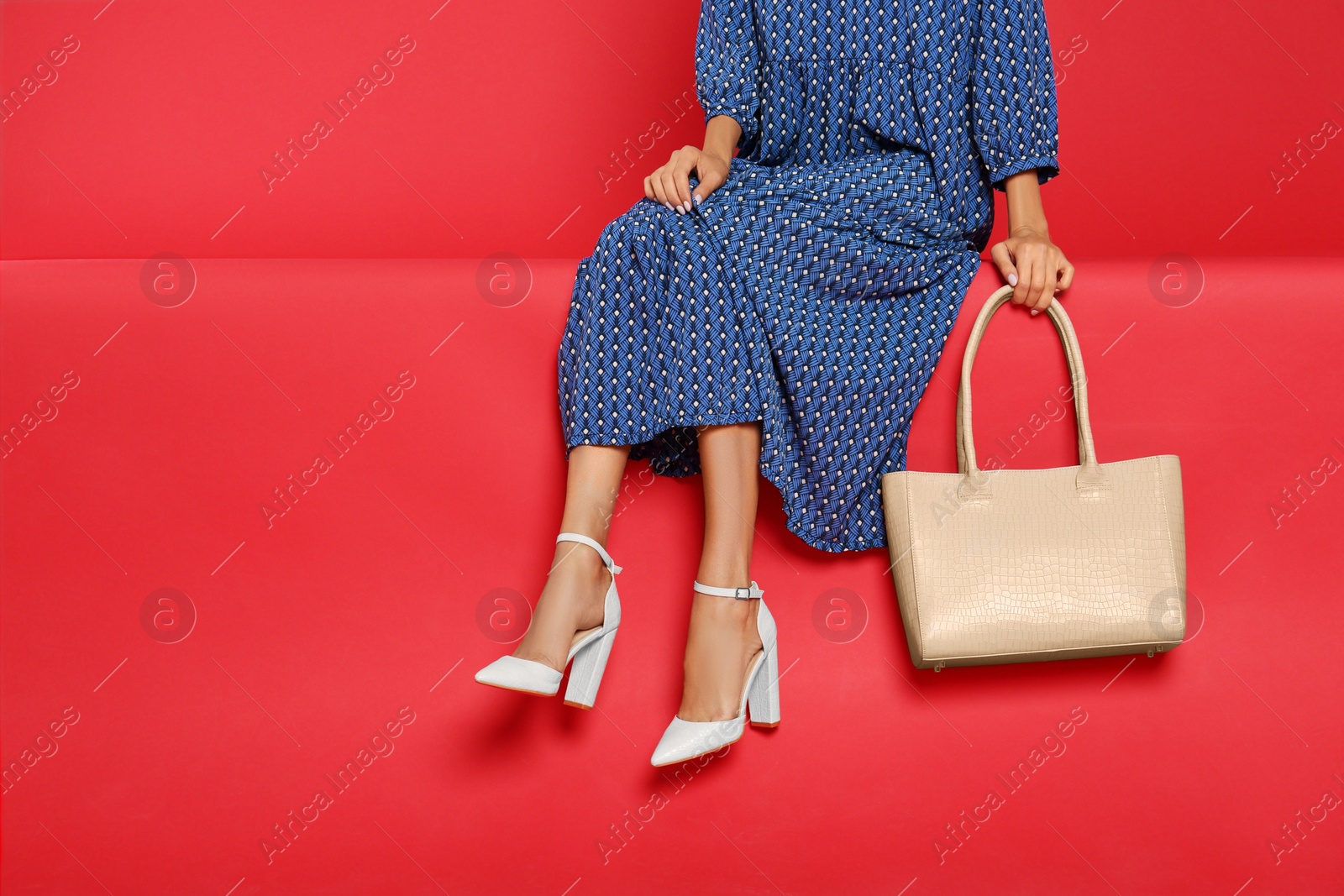 Photo of Woman with stylish bag on red background, closeup. Space for text