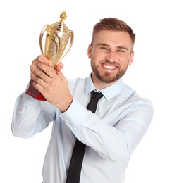 Photo of Portrait of happy young businessman with gold trophy cup on white background
