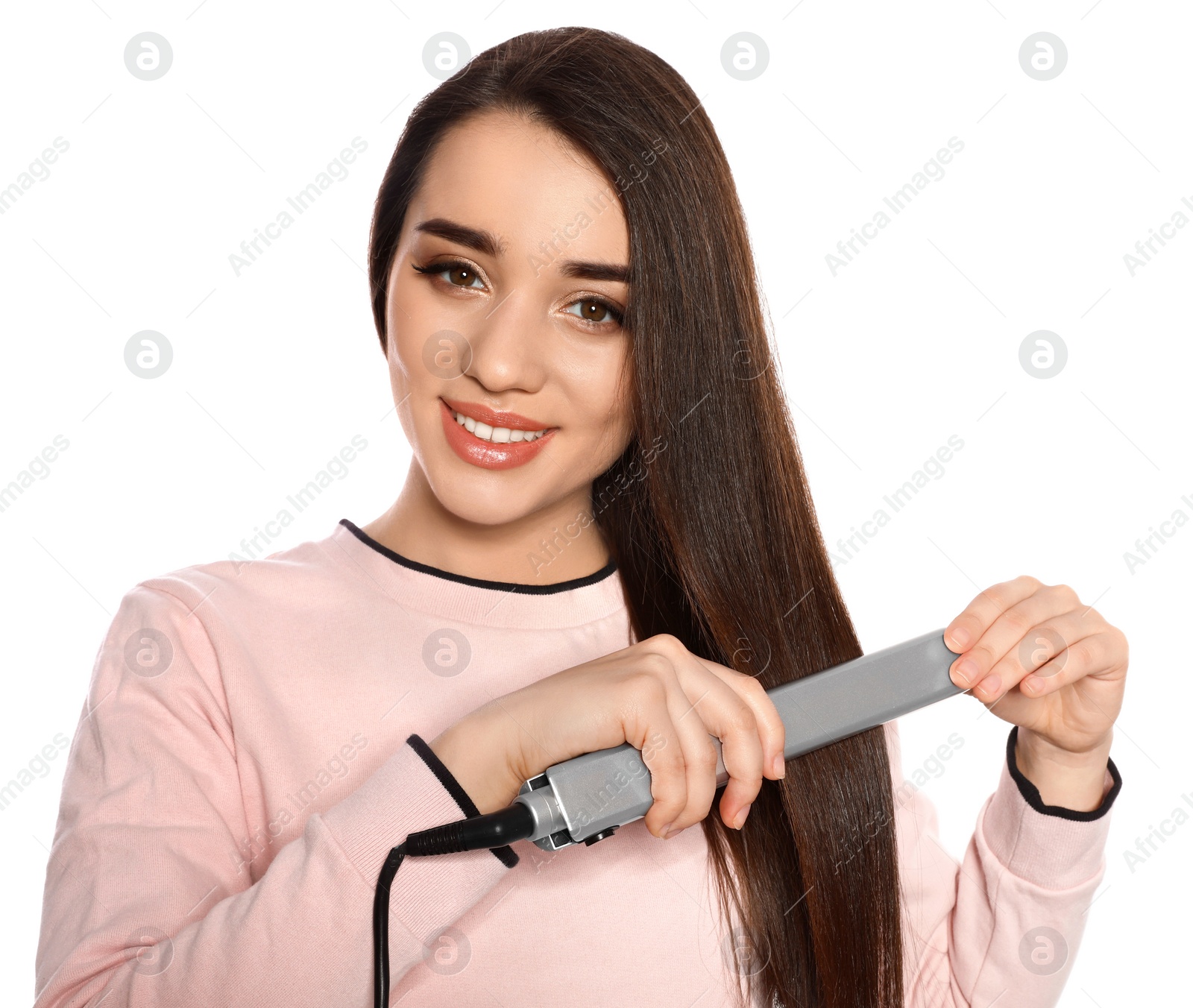 Photo of Happy woman using hair iron on white background