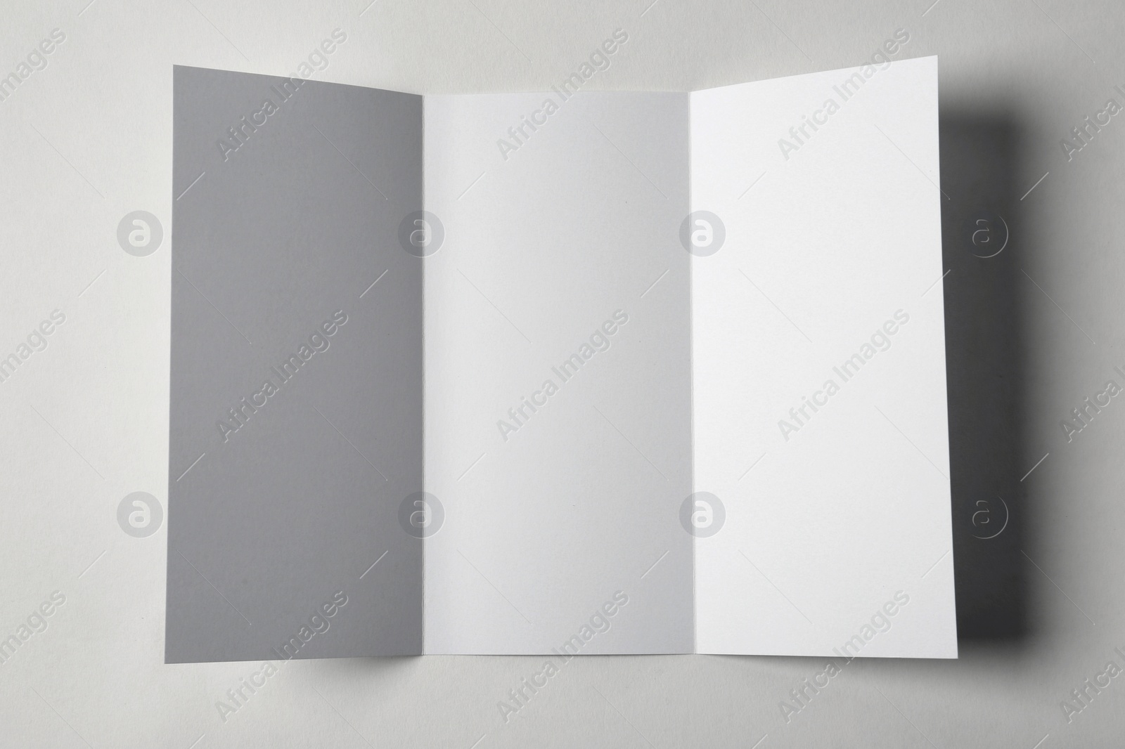 Photo of Blank brochure on white background, above view. Mock up for design