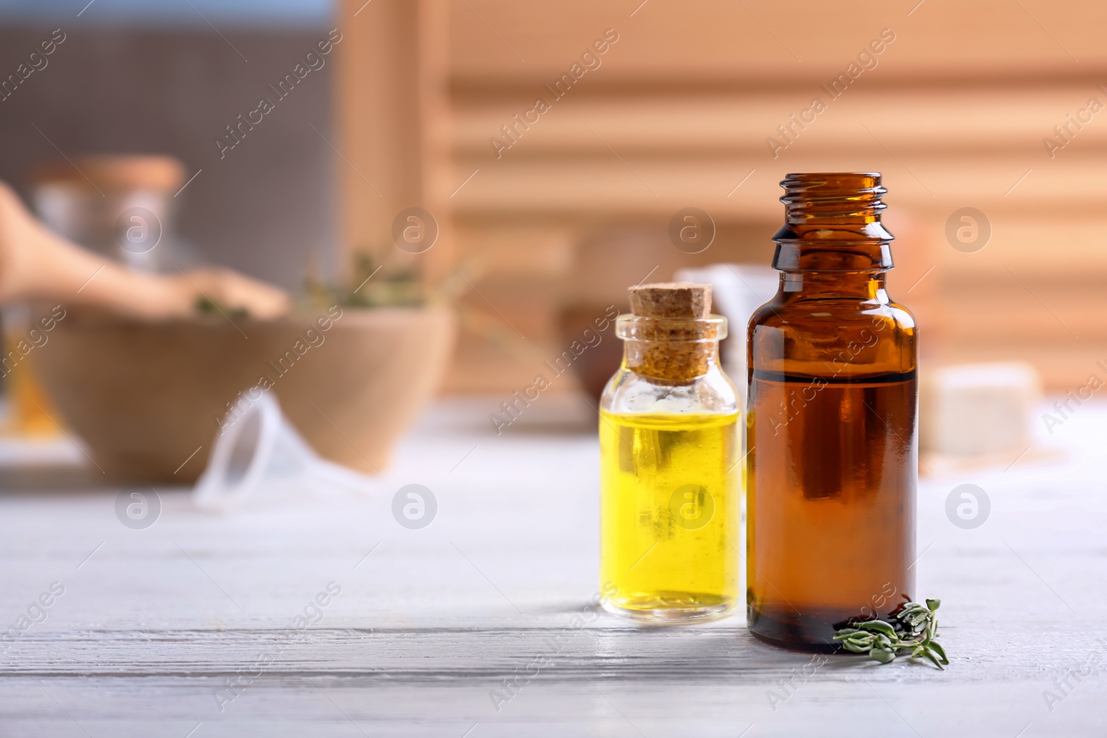 Photo of Bottles with essential oils on wooden table