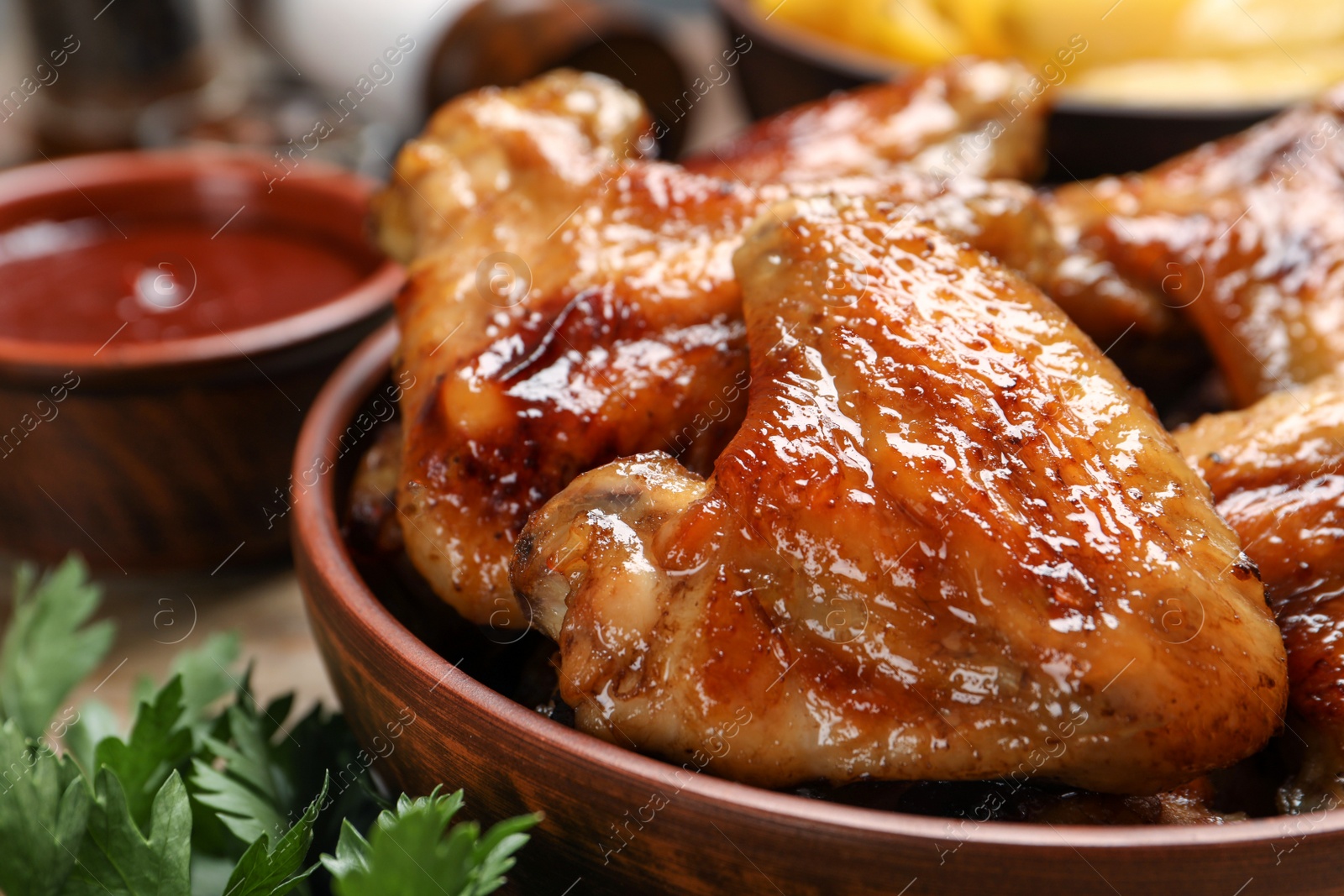 Photo of Closeup view of delicious fried chicken wings in bowl