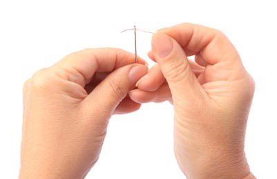 Photo of Woman threading sewing needle on white background, closeup