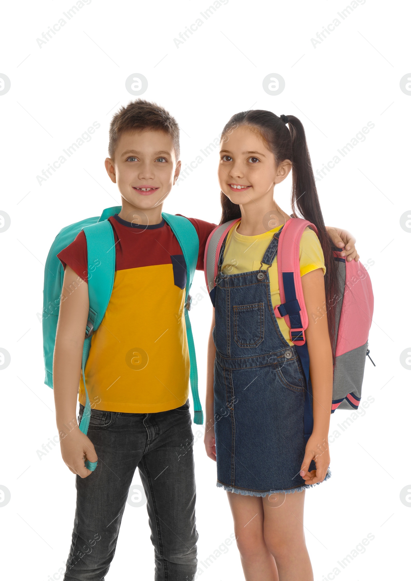 Photo of Little school children with backpacks on white background