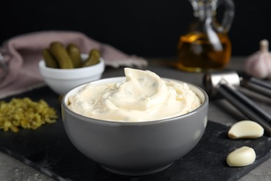 Photo of Tasty tartar sauce and ingredients on table, closeup