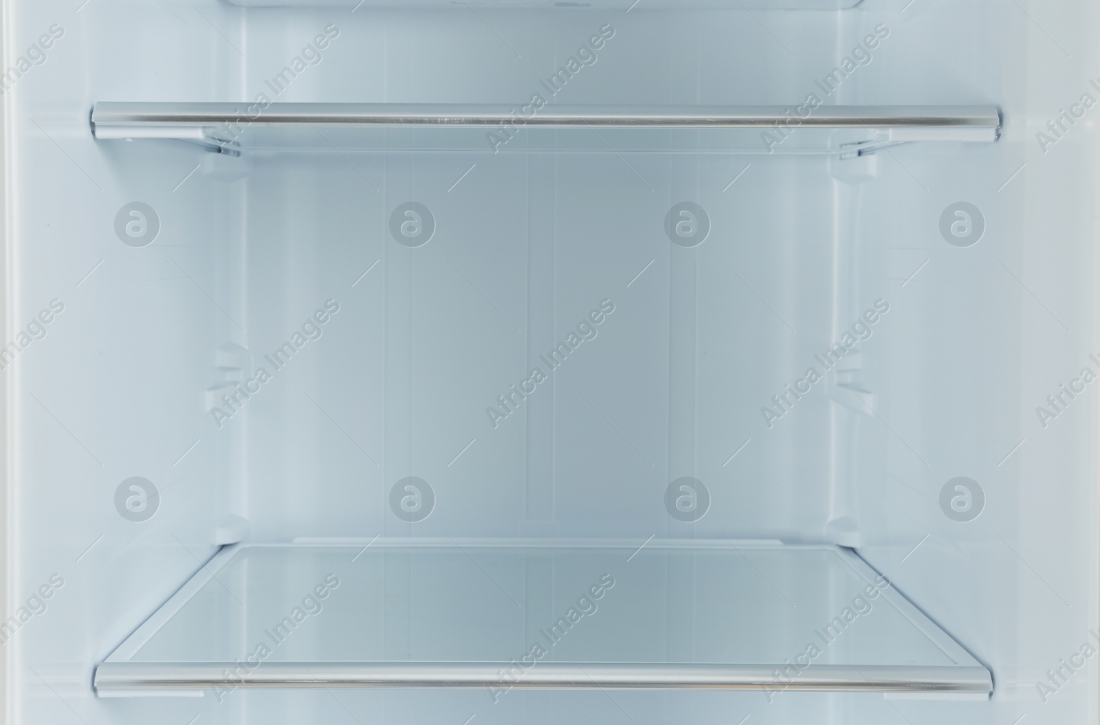 Photo of Shelves of empty modern refrigerator, closeup view