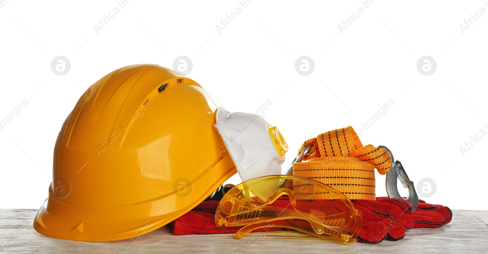 Photo of Set of safety equipment on table against white background