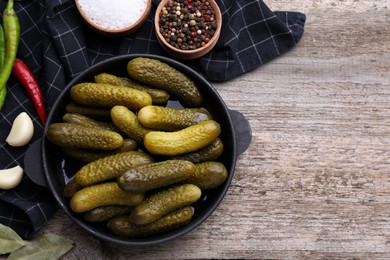 Photo of Pickled cucumbers and ingredients on wooden table, flat lay. Space for text