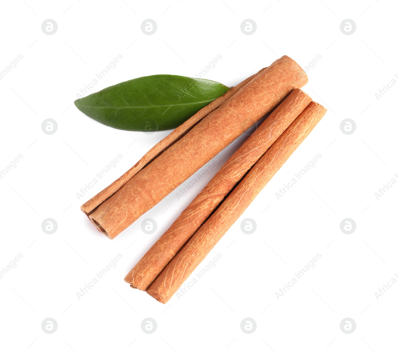 Photo of Cinnamon sticks and green leaf isolated on white, top view