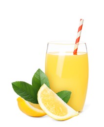 Glass of lemon juice, fresh fruits and green leaves on white background