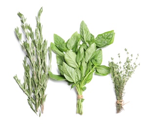 Photo of Rosemary, basil and thyme on white background, top view. Aromatic herbs