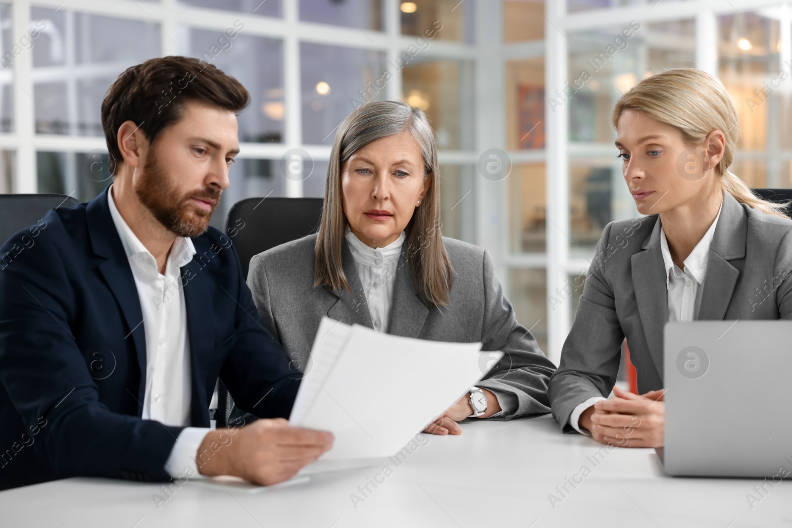 Photo of Lawyers working together at table in office