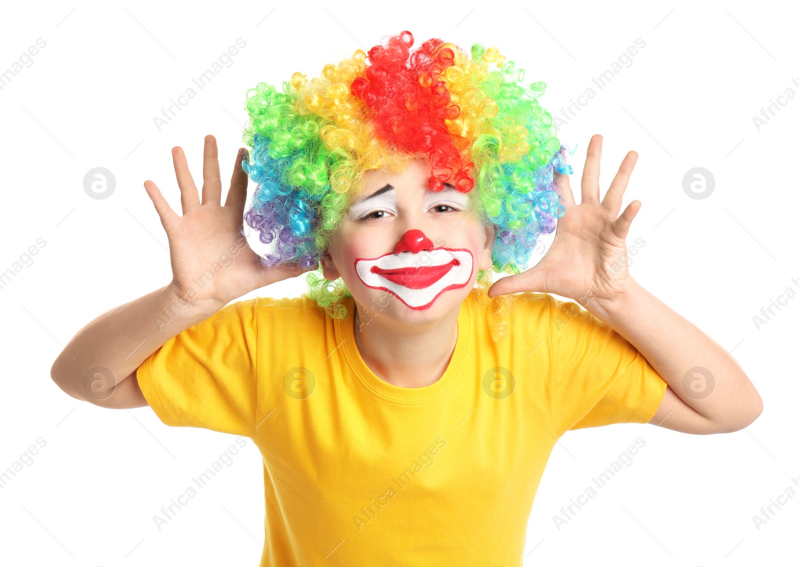 Photo of Preteen boy with clown makeup and wig on white background. April fool's day