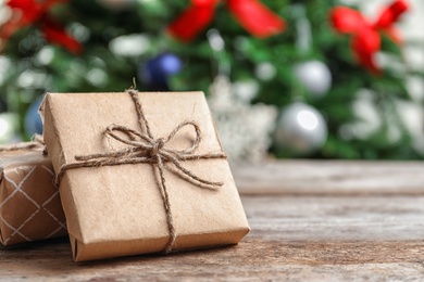 Photo of Beautiful gift boxes and blurred Christmas tree on background