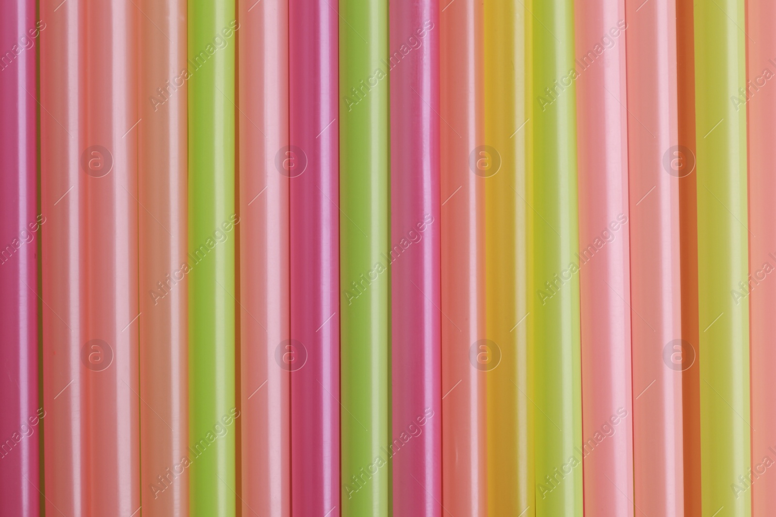 Photo of Colorful plastic straws as background, top view