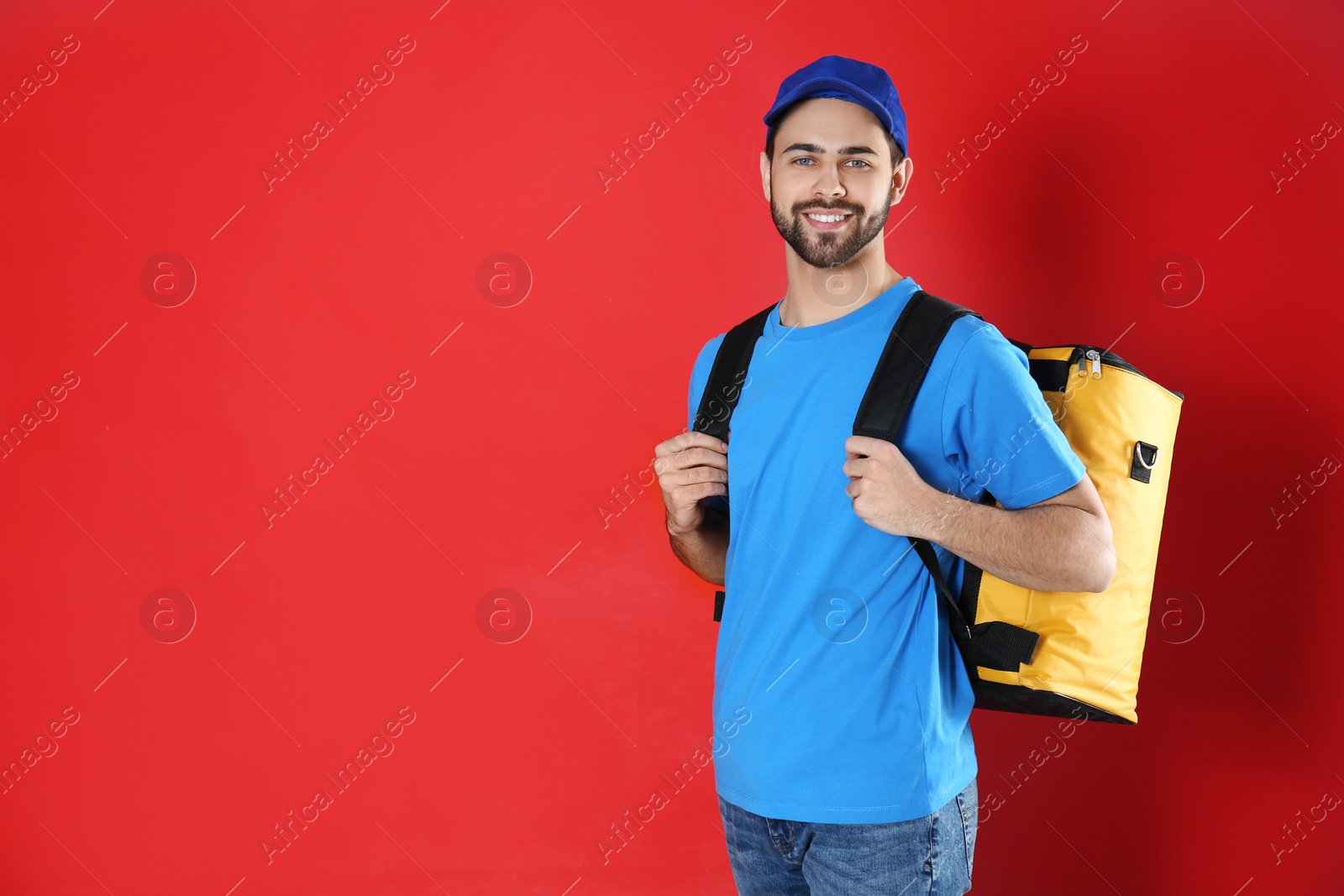 Photo of Courier with thermo bag on red background, space for text. Food delivery service