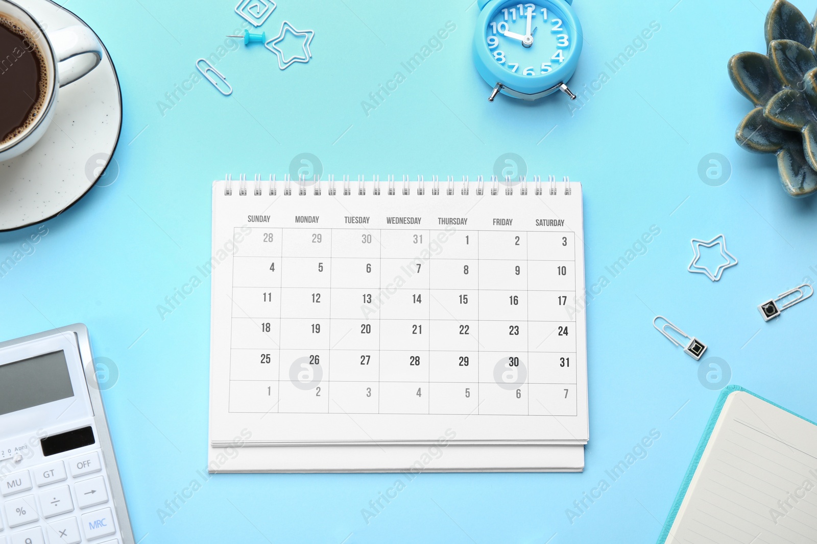 Photo of Flat lay composition with calendar on light blue background