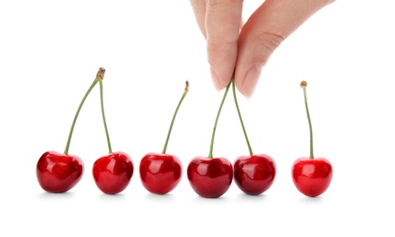 Photo of Woman holding sweet red cherries on white background