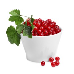 Tasty ripe redcurrants and green leaves in bowl isolated on white