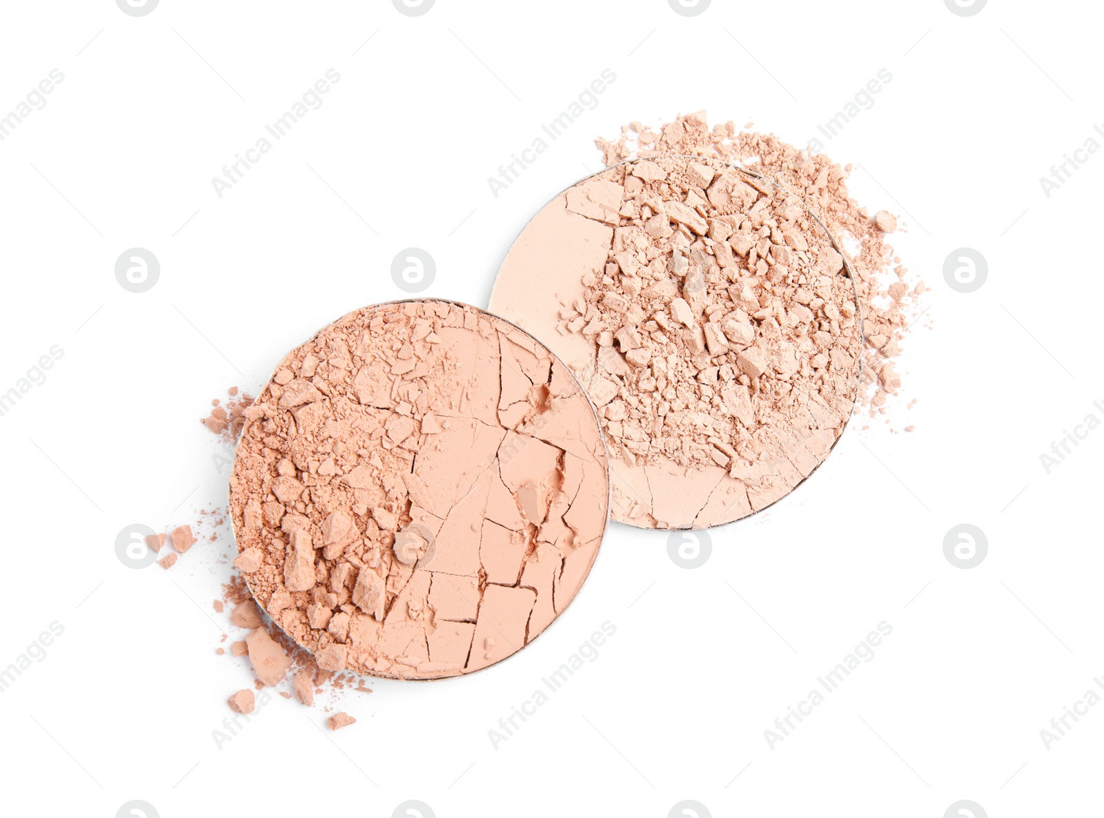 Photo of Different broken face powders on white background, top view