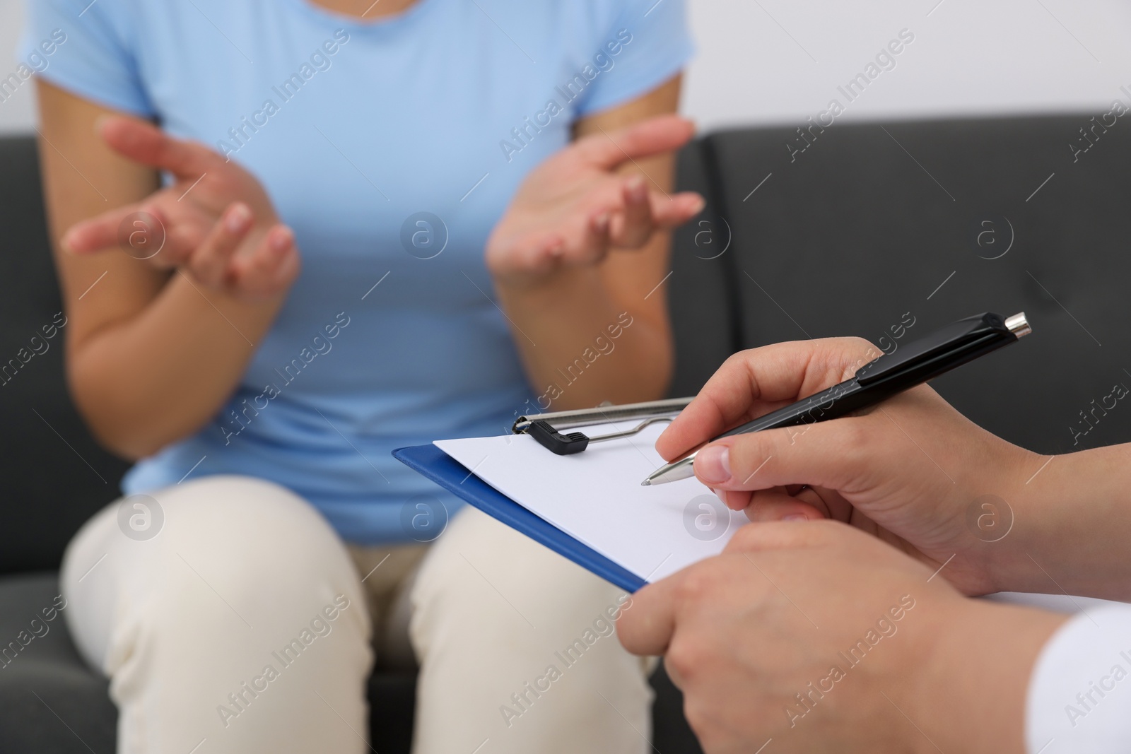 Photo of Professional psychologist working with woman in office, closeup