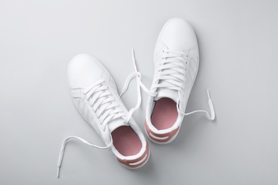 Photo of Pair of trendy sneakers on light background, flat lay