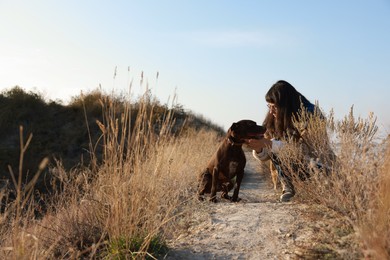 Photo of Woman with her German Shorthaired Pointer dog outdoors, space for text