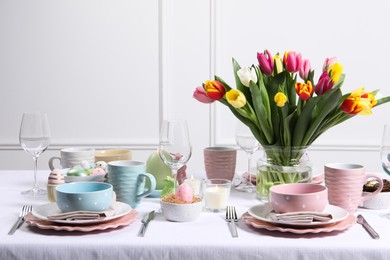 Photo of Festive table setting with beautiful flowers. Easter celebration