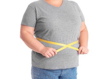 Overweight woman measuring waist before weight loss on white background