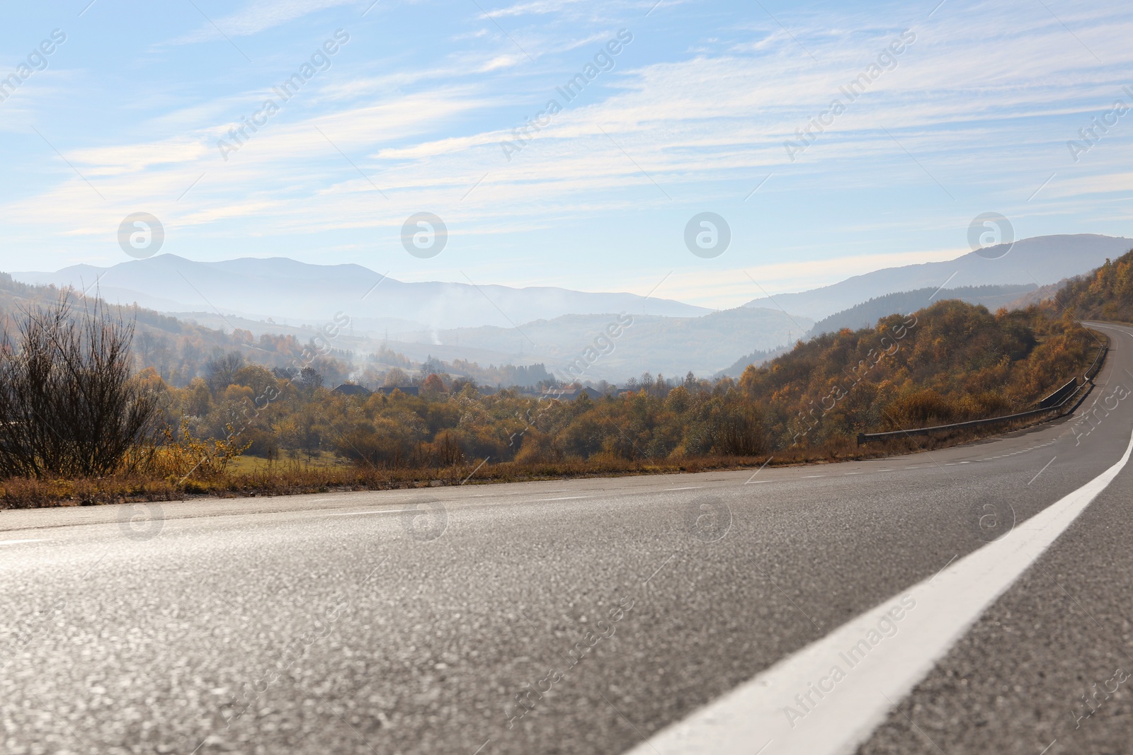 Photo of Landscape with asphalt road leading to mountains