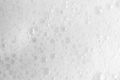 Photo of White fluffy foam as background, top view