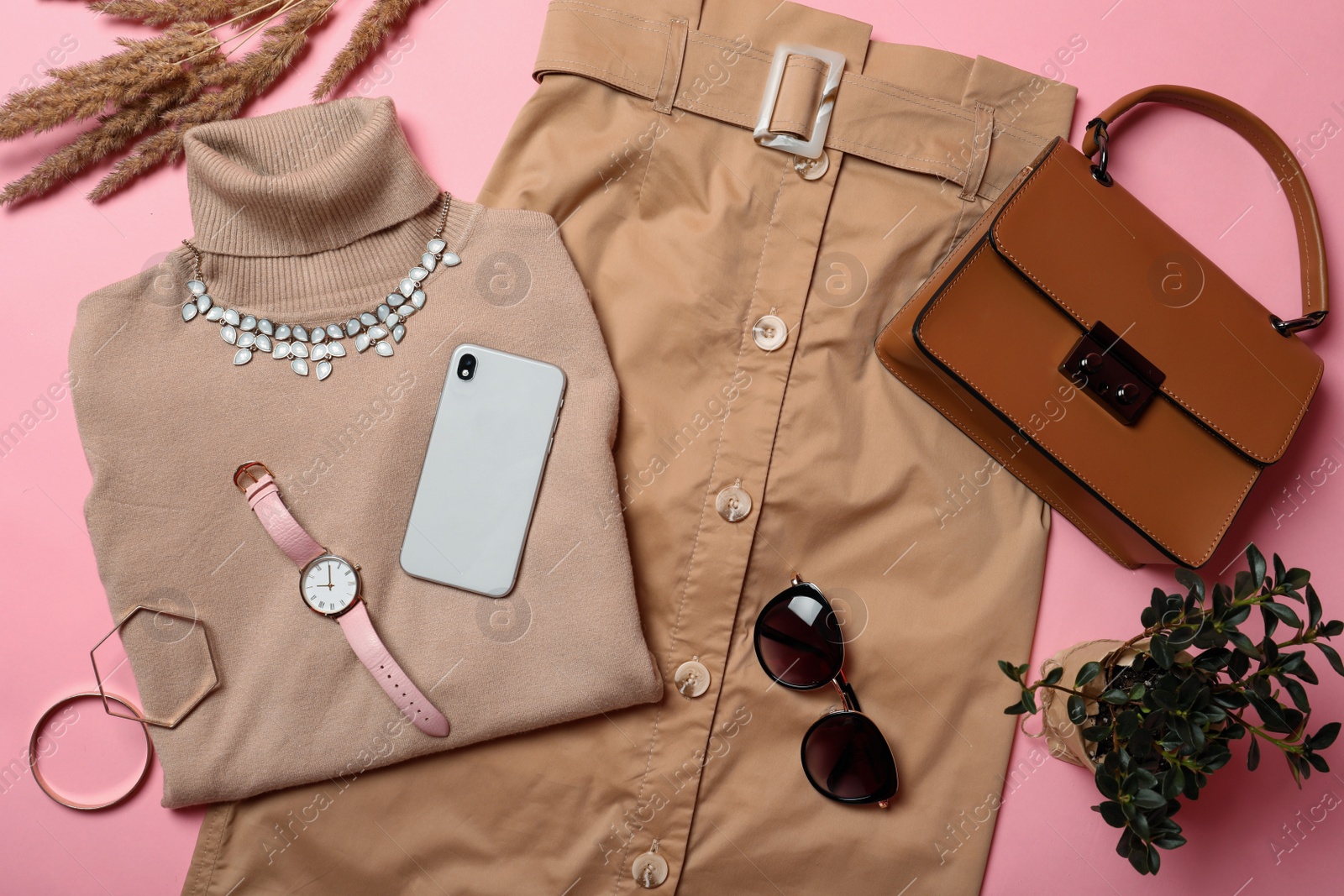 Photo of Stylish clothes, smartphone and accessories on pink background, flat lay