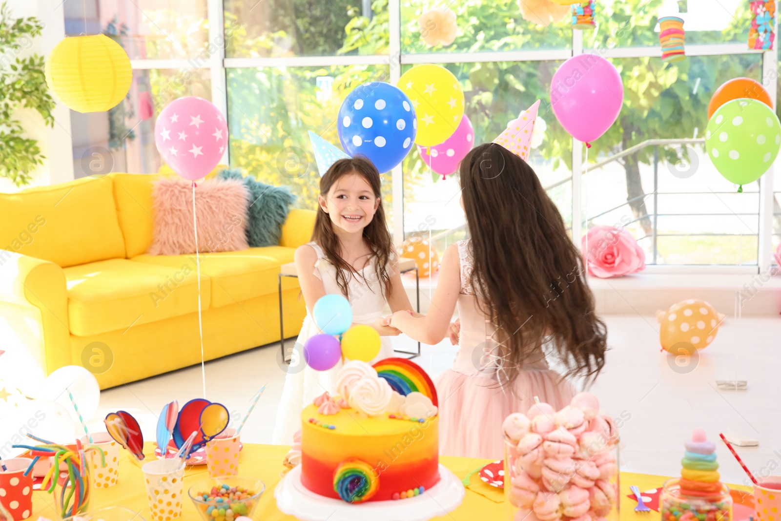 Photo of Cute girls playing together at birthday party indoors
