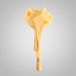 Image of Tasty cheese stretching in air on grey background