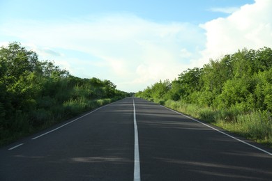 Photo of Asphalt road running through countryside on sunny day