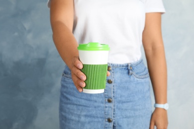 Photo of Woman with carton cup, closeup. Mock up for design