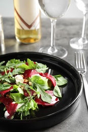 Plate with delicious beet salad served on table