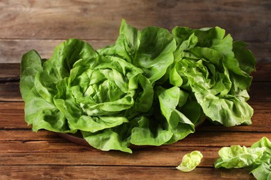 Photo of Fresh green butter lettuce on wooden table