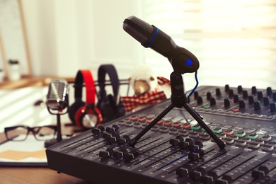 Photo of Microphone and professional mixing console in radio studio