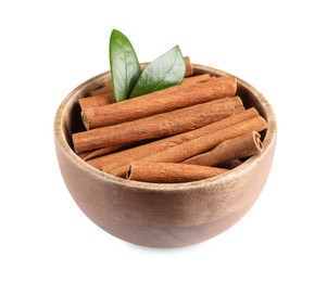 Cinnamon sticks and green leaves in bowl isolated on white