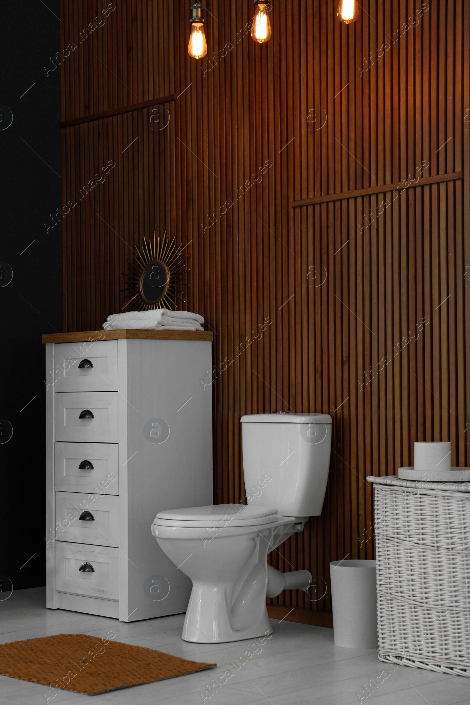 Photo of Ceramic toilet bowl in stylish bathroom. Idea for interior design