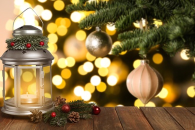 Christmas lantern and decorations on table, space for text. Bokeh effect