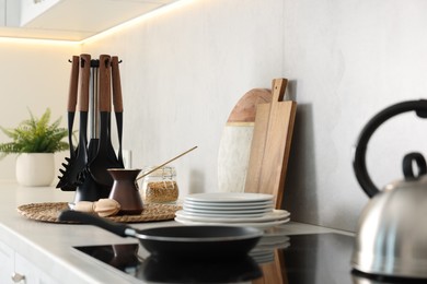 Set of different utensils and dishes on countertop in kitchen