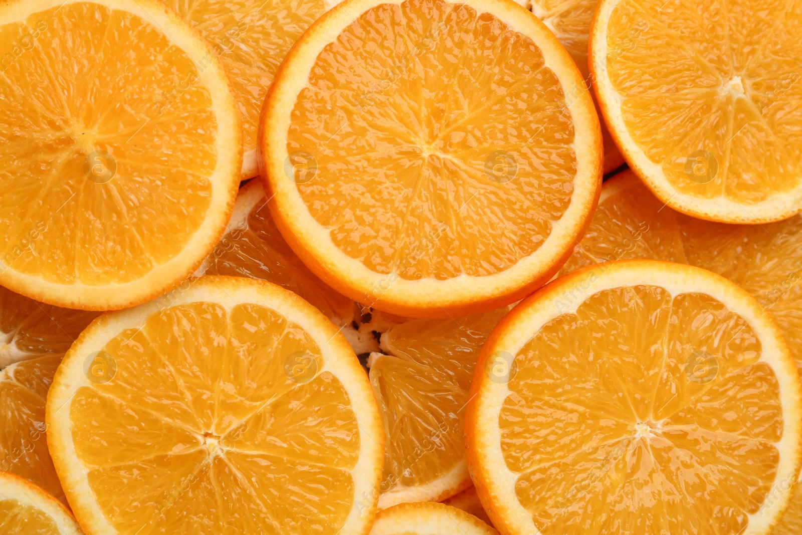 Photo of Slices of delicious oranges as background, closeup