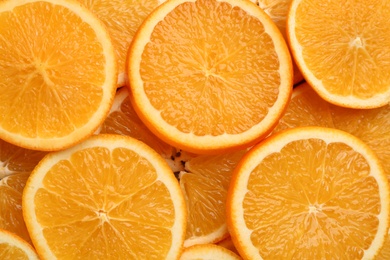 Photo of Slices of delicious oranges as background, closeup