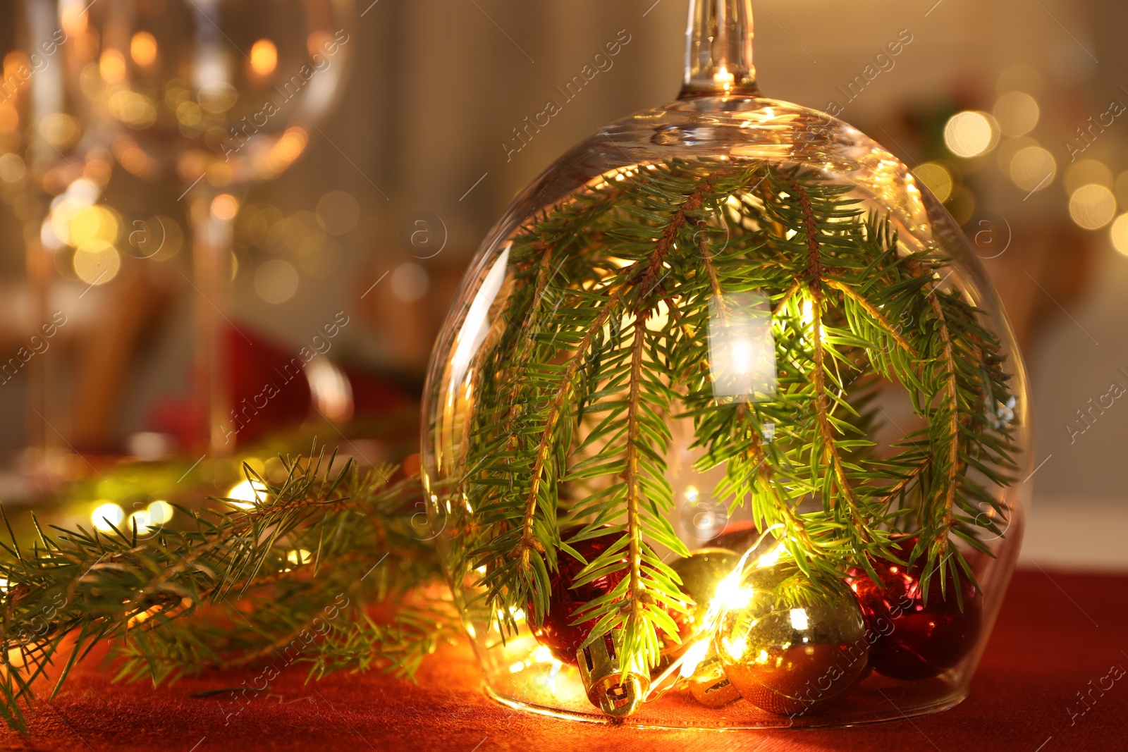 Photo of Christmas celebration. Glass and festive decor on table, closeup