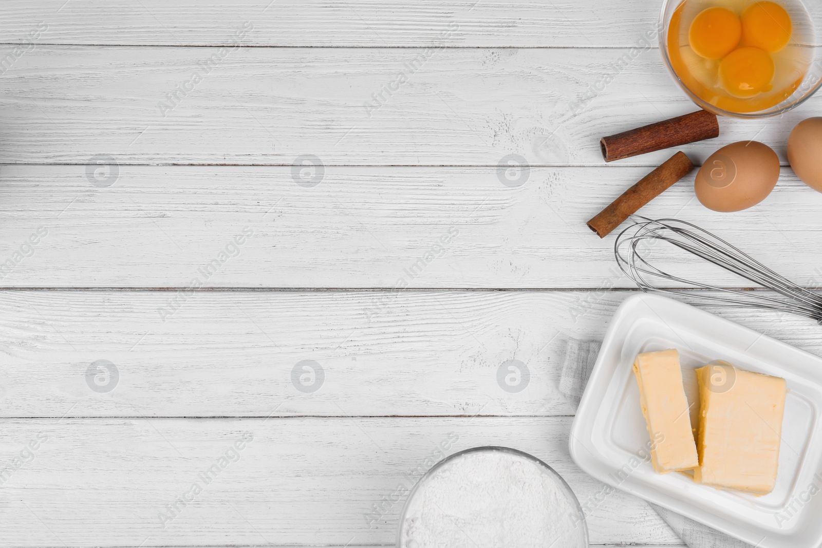 Photo of Flat lay composition with eggs and other ingredients  on white wooden table, space for text. Baking pie